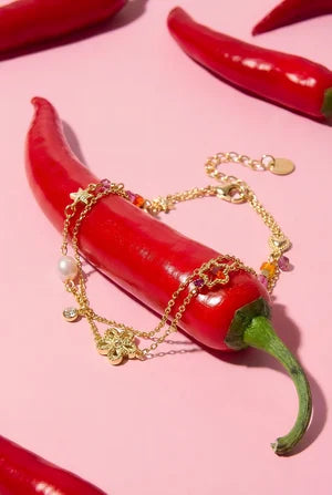 Bedelarmband met ster en bloemcharms, parels, steentjes